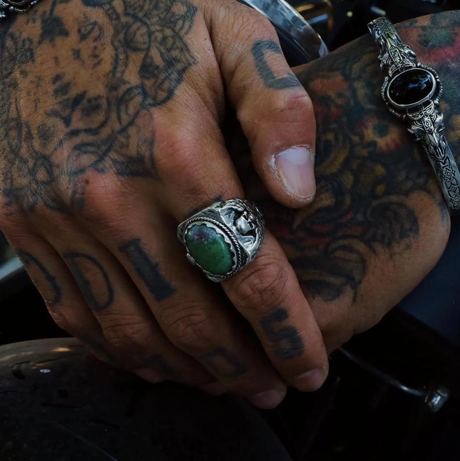 A bold and intricately detailed skull ring made from solid 925 sterling silver, adorned with a vivid green ruby zoisite gemstone. Designed to reflect individuality and personal strength, this handcrafted piece is perfect for gothic fashion lovers, bikers, and men with a rebellious spirit. With its substantial weight and detailed skull motifs, this ring is a powerful expression of style and identity.