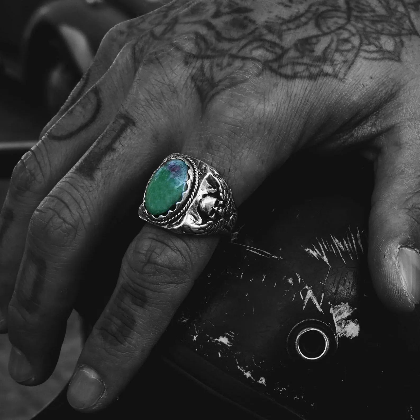 An artisan-made sterling silver ring showcasing a natural ruby zoisite stone and darkly elegant skull engravings, symbolizing fearlessness, transformation, and personal power. This handcrafted men's ring offers both durability and symbolism, ideal for daily wear or special moments. Whether it's a 1st, 5th, or 10th anniversary, this piece delivers deep emotional and visual impact.