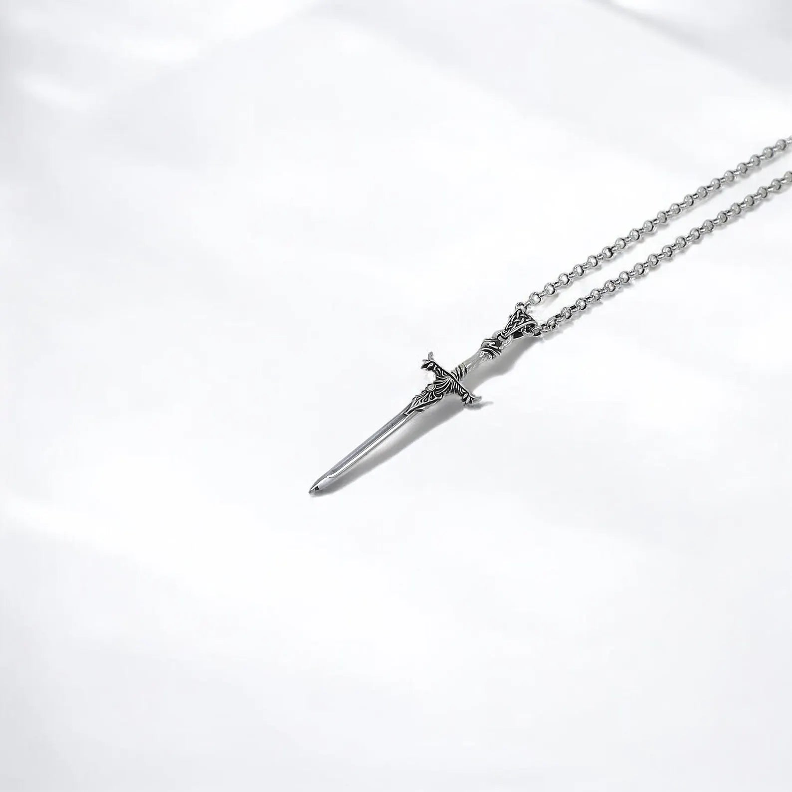 This silver sword pendant tells a story of bravery and purpose through its minimalist blade form and gothic embellishments. The necklace captures the spirit of fantasy realms and medieval lore, offering a wearable piece of strength for men who walk a bold, intentional path and appreciate handmade silver jewelry.