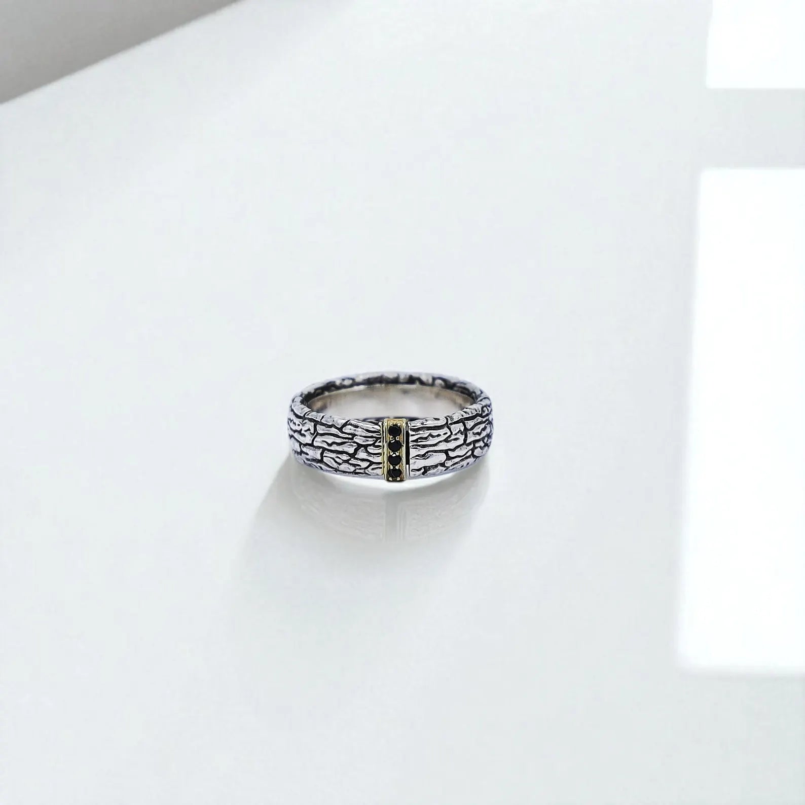 Top-down perspective of the men's silver band ring, showcasing the rugged texture and centered gemstone-accented gold bar. The fusion of organic engraving and luxurious metallic contrast makes it a perfect gift for birthdays, anniversaries, or meaningful moments.