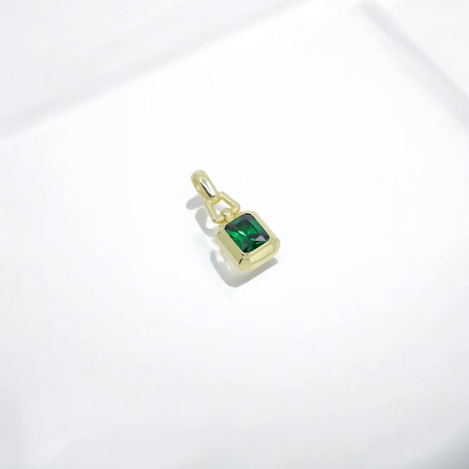 Lab-created emerald pendant handcrafted in 14K gold plated sterling silver, showcasing an intricate emerald-cut design. Known for its deep green hue and powerful symbolism, this gemstone necklace reflects elegance, renewal, and strength. A standout handmade jewelry piece for Etsy, Pinterest, and Google shoppers seeking luxurious, meaningful accessories.