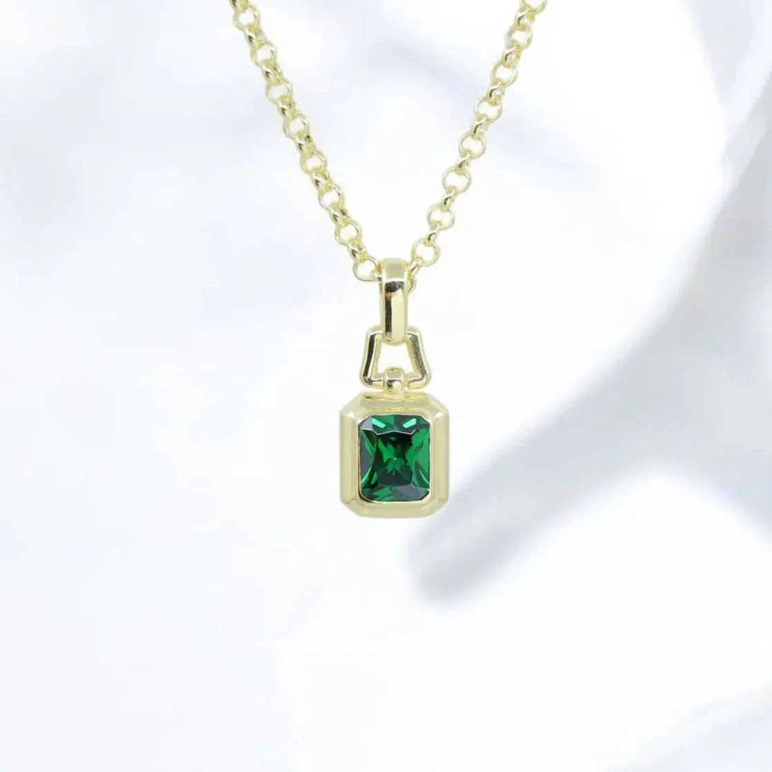 Handcrafted gold-plated sterling silver necklace featuring a radiant lab-created emerald gemstone in an elegant emerald cut. This luxurious pendant blends timeless style with modern design, making it the perfect statement jewelry for both men and women. A top-rated gift idea on Etsy for birthdays, anniversaries, and graduations. Adds elegance and vibrant color to any outfit.