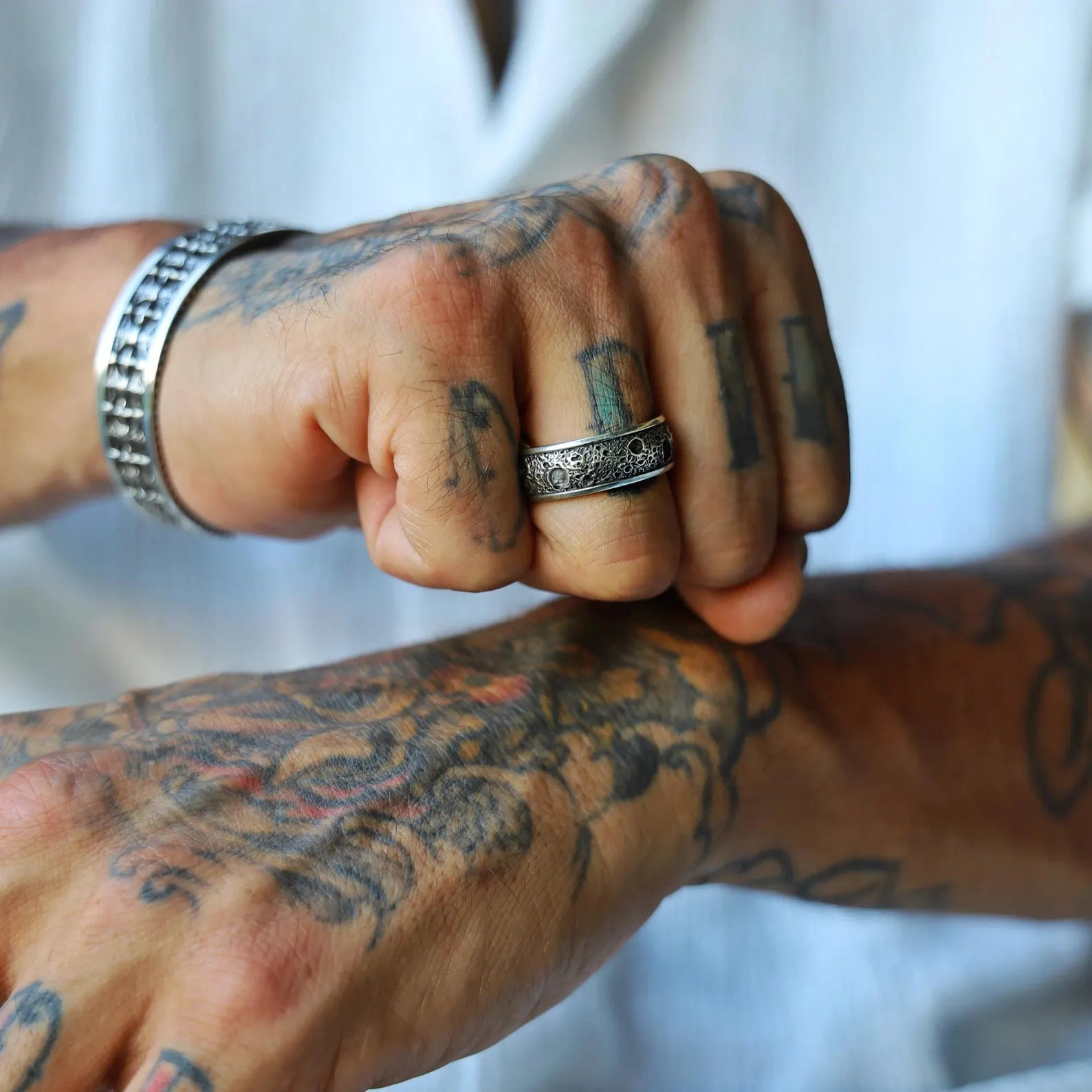 Masculine and minimalist band ring made from textured sterling silver, designed with a gothic touch for a bold yet subtle look, perfect as a statement accessory or alternative wedding band for men.