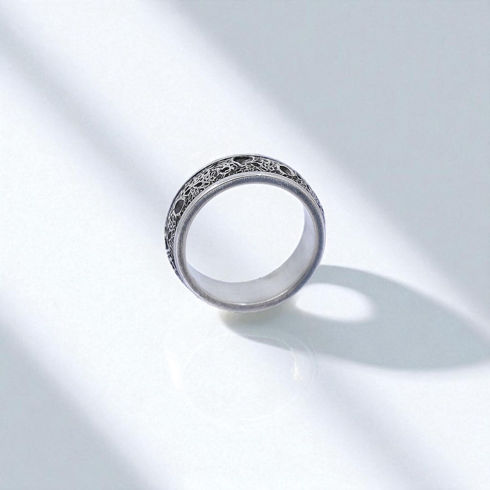 Rotated vertical angle capturing the ring’s band width and texture relief, showcasing the careful hand-engraving and polished interior. Designed for both comfort and style, this ring is suitable for daily wear or as a gothic wedding band.