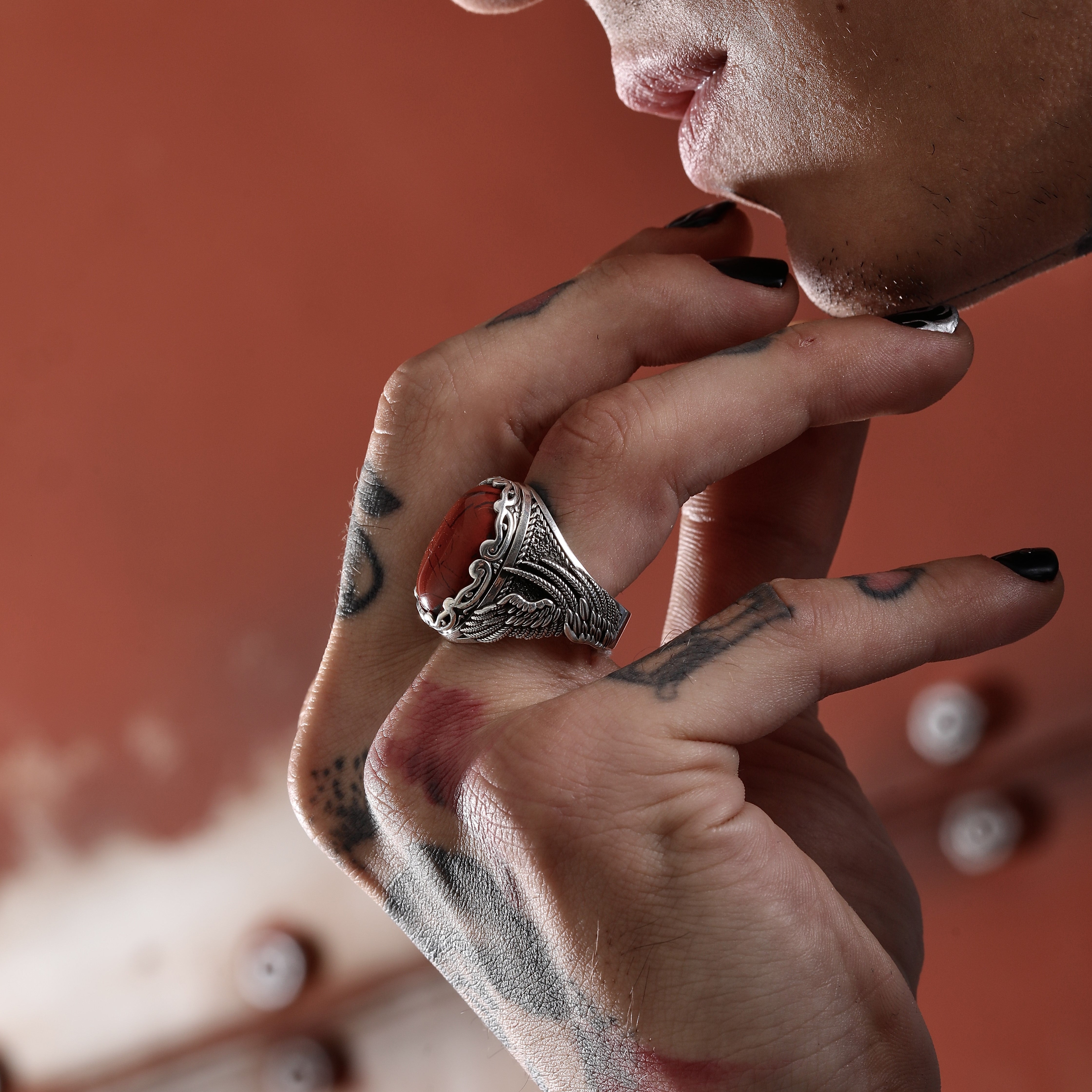 A striking men’s gothic ring made from sterling silver, featuring a vivid red jasper gemstone framed by detailed wing-like engravings. This handcrafted piece is not only an accessory but a representation of boldness, passion, and timeless masculinity. The rich textures and natural elements make it ideal for everyday wear or special occasions, while the option for engraving allows it to become a treasured keepsake for years to come.
