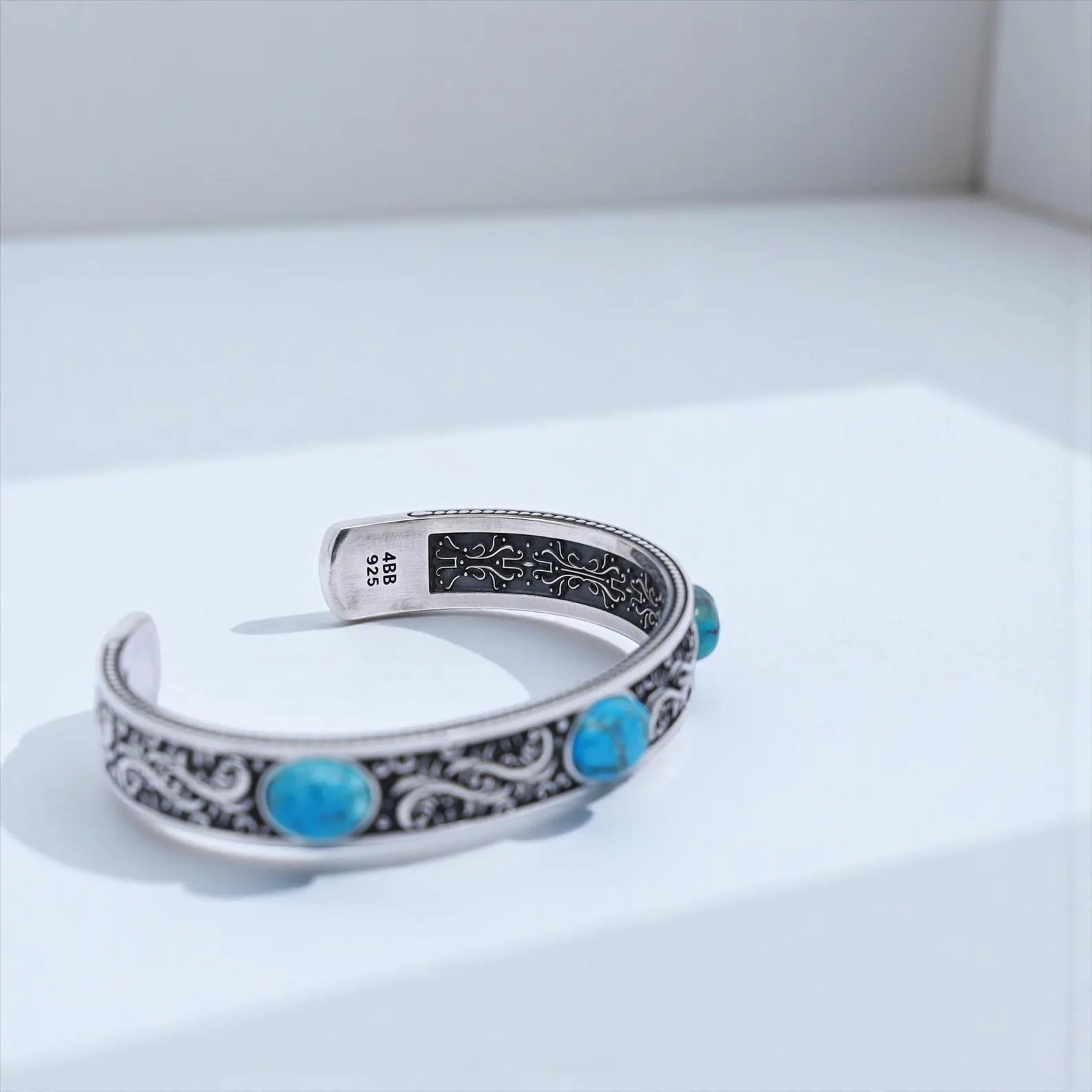 Masculine handcrafted turquoise cuff bracelet for men made from solid 925 sterling silver with bold vintage Western engravings, oxidized finish, and three natural turquoise stones. Adjustable artisan jewelry perfect for cowboys, bikers, and Southwestern fashion.