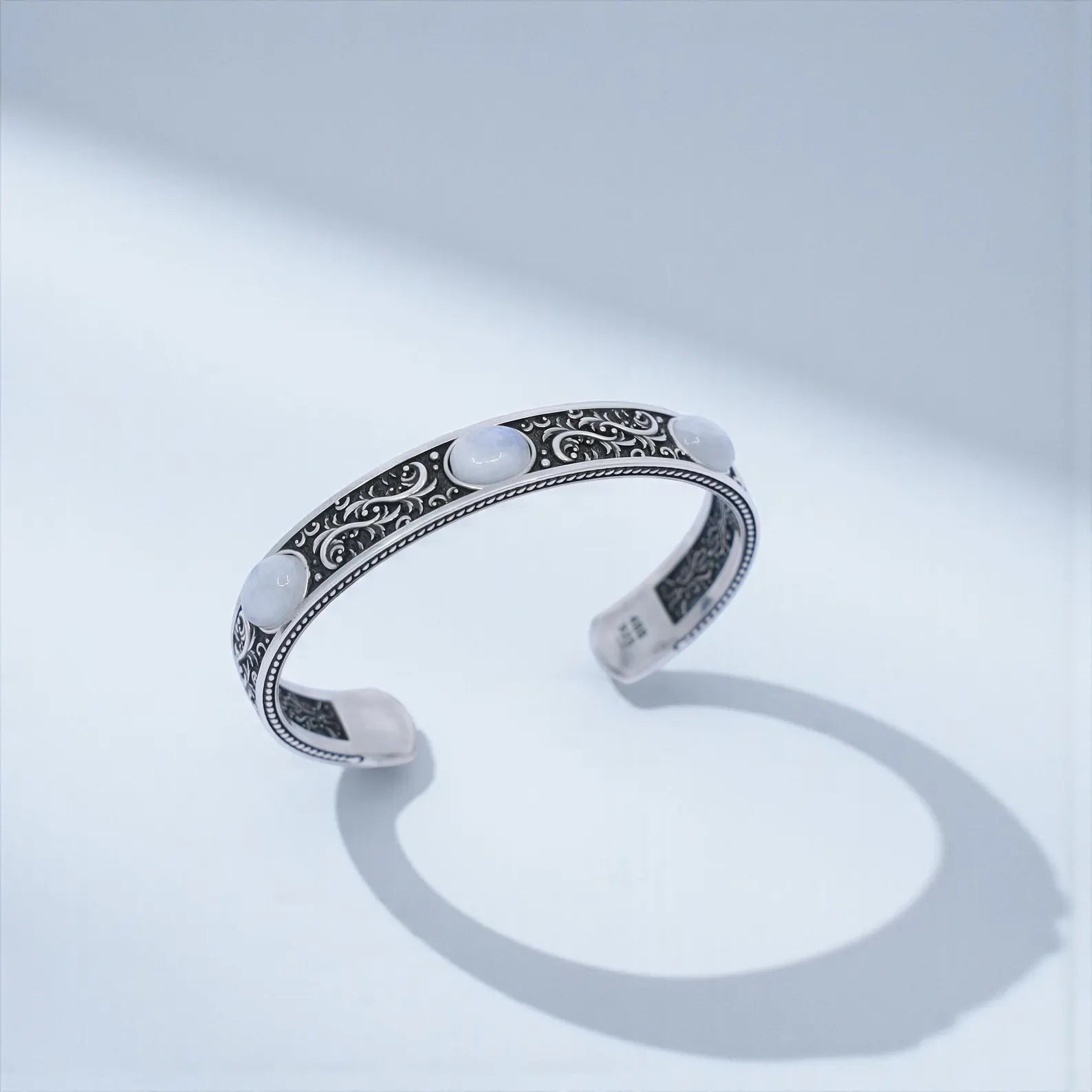 Handcrafted 925 sterling silver moonstone cuff bracelet for men featuring three natural moonstone gemstones set in a bold vintage-engraved Baroque design. Oxidized and hand-polished finish, ideal as a unique Christmas, anniversary, or birthday gift.