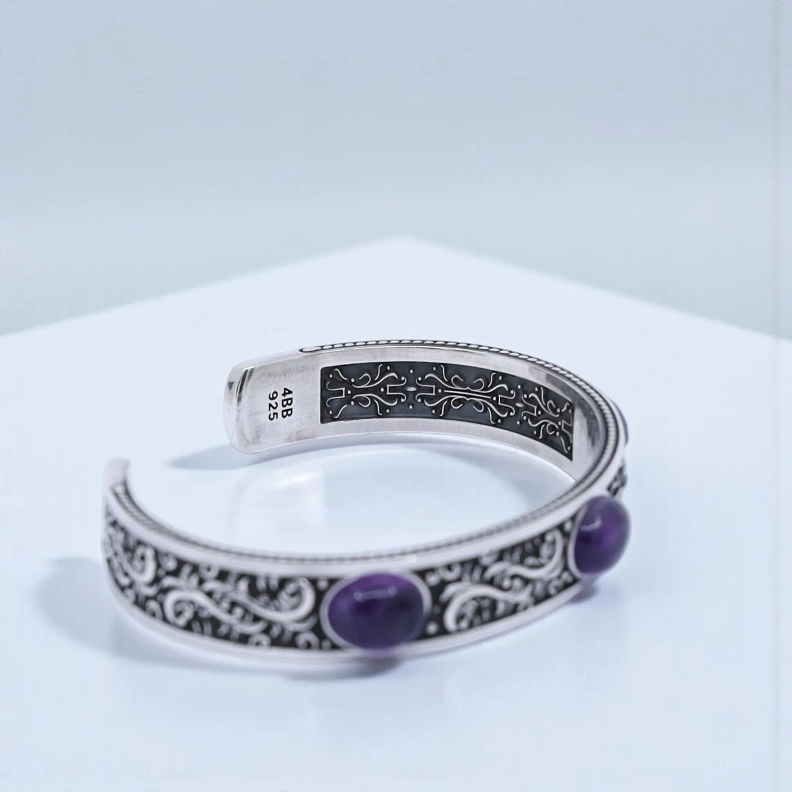 Unisex amethyst cuff bracelet crafted from high-quality 925 sterling silver, featuring bold biker-style engravings and three polished natural amethyst stones. This luxurious, hand-polished cuff can be engraved inside for a personalized touch, making it a thoughtful anniversary, Christmas, or birthday gift for him.