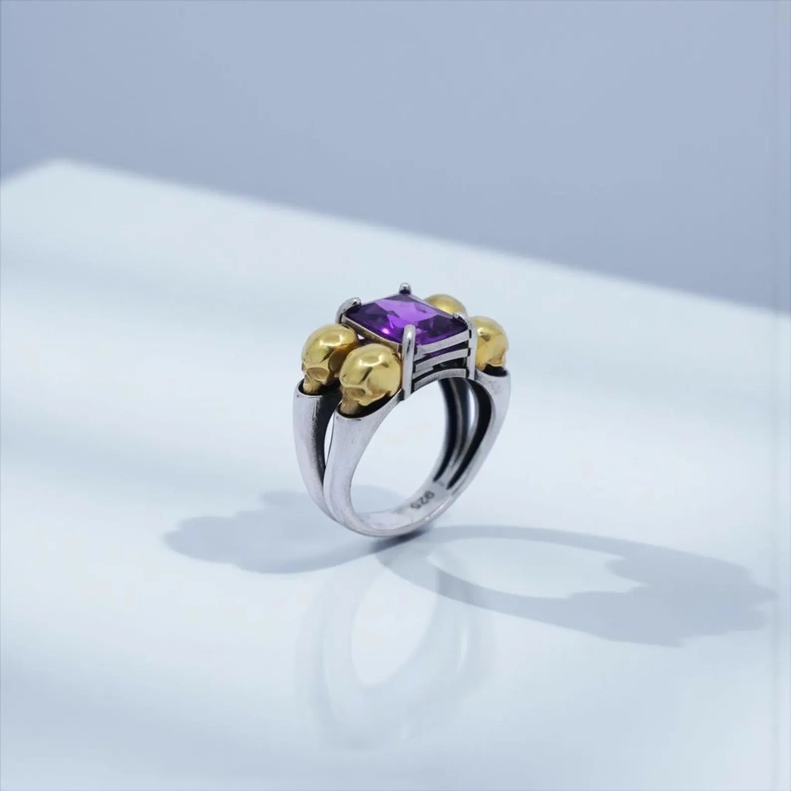 Studio shot of a luxury gothic skull statement ring, emphasizing its emerald gemstone symbolizing strength and protection—ideal for gift for husband, anniversary ring men, and masculine emerald jewelry searches.