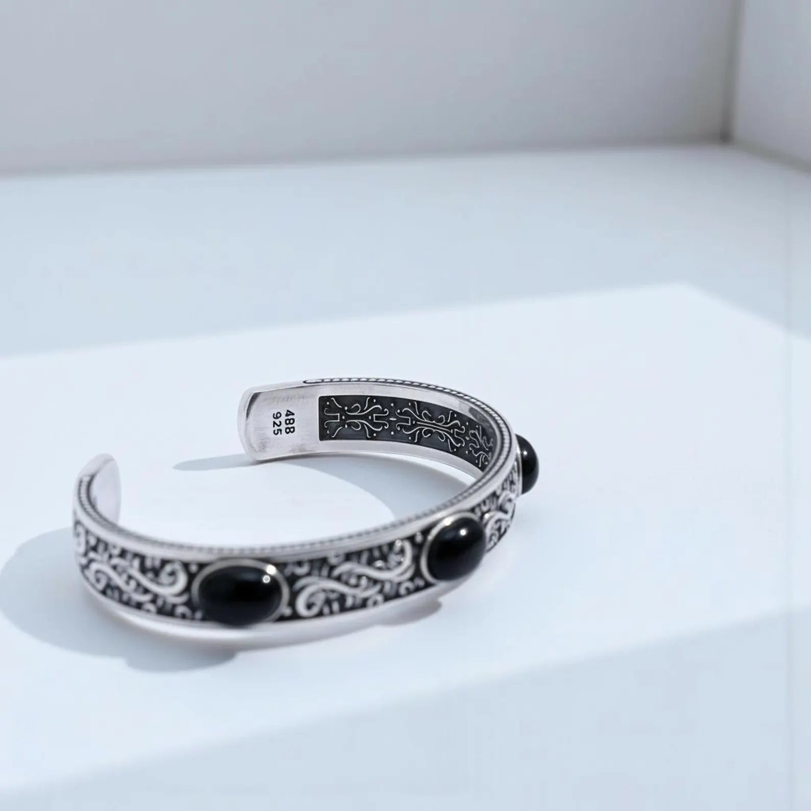 Bold black onyx men’s cuff bracelet featuring chunky sterling silver craftsmanship, engraved vintage-inspired patterns, and adjustable fit for everyday wear or special occasions.