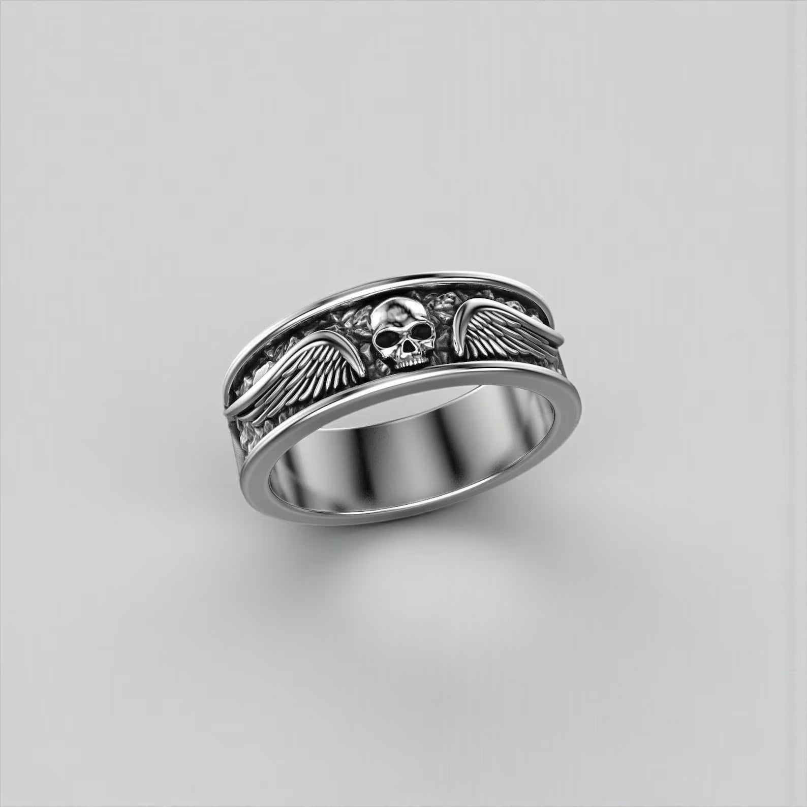 Close-up photo of a handcrafted 925 sterling silver winged skull ring for men, showcasing the detailed jawless skull design and bold gothic biker craftsmanship, perfect for motorcycle enthusiasts seeking unique statement jewelry.