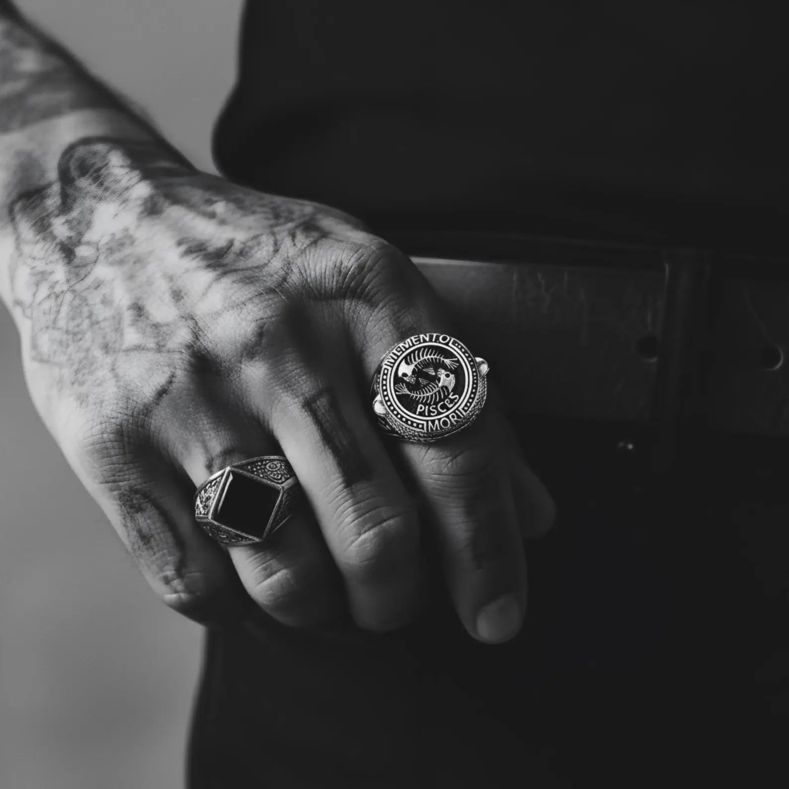 Detailed view of a Memento Mori Pisces ring highlighting the fish skeleton centerpiece, oxidized silver finish, and bold gothic biker style jewelry design.