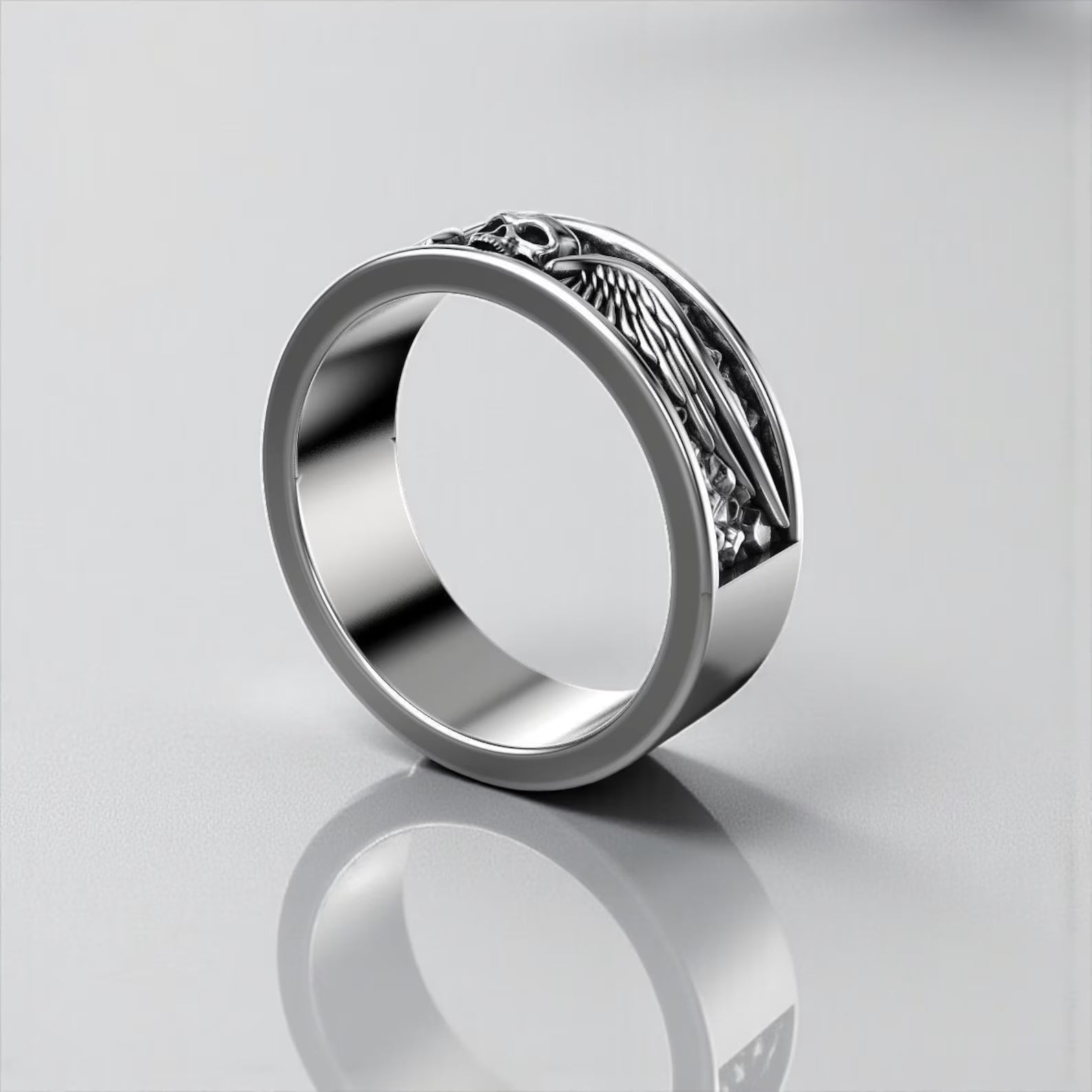 Product display of a handcrafted sterling silver skull ring with wings, designed for motorcycle riders, gothic fashion lovers, and men seeking unique symbolic jewelry representing freedom and fearlessness.