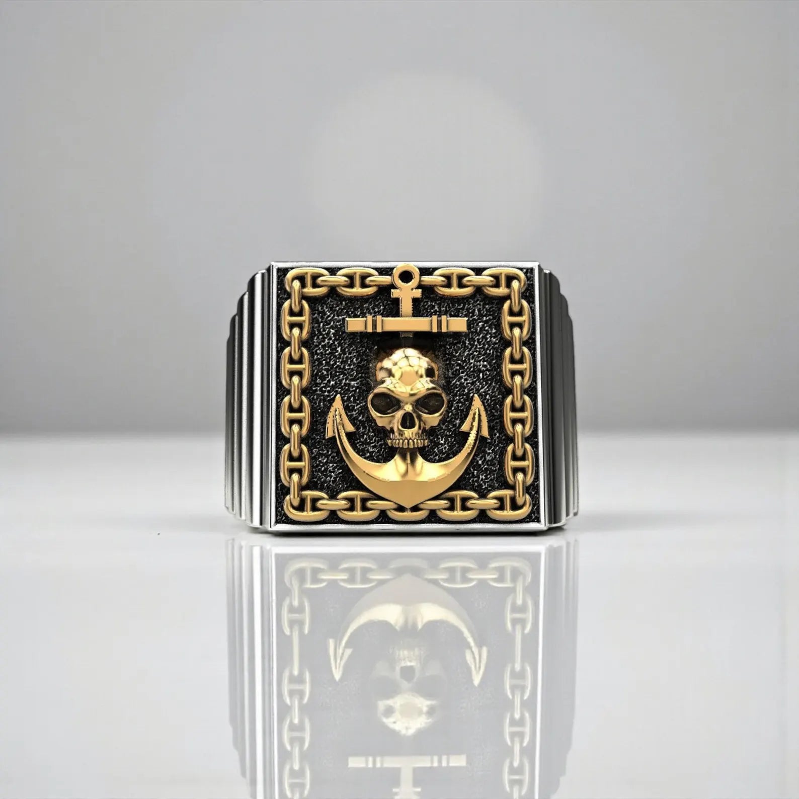 Bold pirate ring for men with skull and anchor motif, crafted in oxidized sterling silver with refined gold detailing for a rugged nautical look