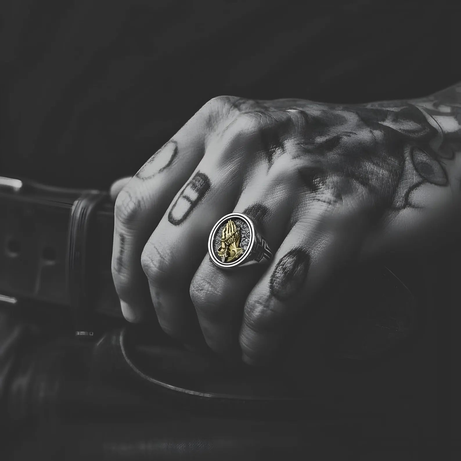 Faith based statement ring for men made from solid sterling silver, decorated with praying hands, rosary elements, and a Christian cross highlighted in gold